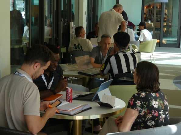 A meeting at a round table in the hotel lobby